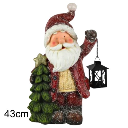 Figura decorativa de Pai Natal segurando uma lanterna e uma árvore de Natal, ideal para decoração natalícia